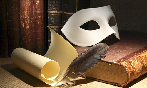 Dramaturgy concept. Vintage still life with quill and scroll near mask and old books on dark background